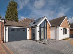 a house with two garages and a driveway