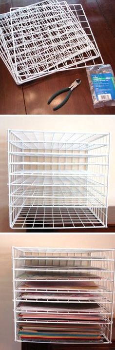 a white wire basket sitting on top of a wooden floor next to scissors and paper