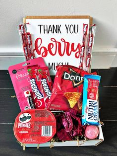 a box filled with candy and candies next to a thank you sign