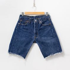 Vintage Levi's 501 cut-off denim shorts in navy-blue - button fly - 5 pockets - high waist - material: 100% cotton SIZE from the label: W30 best fits women: M MEASUREMENTS waist: 29 inches (74 cm) hips: 41 inches (104 cm) rise: 10.5 inches (27 cm) length: 18 inches (46 cm) inseam: 9 inches (23 cm) CONDITION - 9/10 - The cutoffs in great pre-owned vintage condition. Washed, ready to wear. Dark Wash Rigid Denim Summer Shorts, Dark Wash Rigid Denim Shorts For Summer, Summer Dark Wash Rigid Denim Shorts, Dark Wash Rigid Denim Jean Shorts, Denim Blue Rigid Denim Shorts, Rigid Denim Jean Shorts For Summer, Summer Rigid Denim Jean Shorts, Medium Wash Cutoff Jean Shorts In Rigid Denim, Medium Wash Cutoff Rigid Denim Shorts