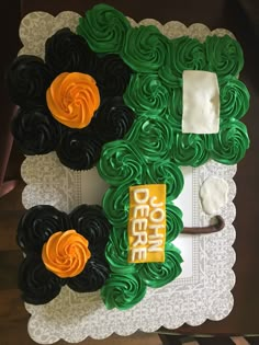 the cake is decorated with green and orange icing