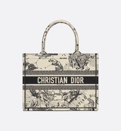 Introduced by Maria Grazia Chiuri, Creative Director of Christian Dior, the Dior Book Tote has become a staple of the Dior aesthetic. Designed to hold all the daily essentials, the style is fully embroidered with the latte and black Dior Zodiac motif created by the artist Pietro Ruffo. Adorned with the Christian Dior Paris signature on the front, the medium tote exemplifies the House's signature savoir-faire and may be carried by hand or worn over the shoulder.. Dior Zodiac, Zodiac Embroidery, Dior Aesthetic, Dior Book, Christian Dior Paris, Dior Paris, Christian Dior Fashion, Dior Book Tote, Maria Grazia Chiuri