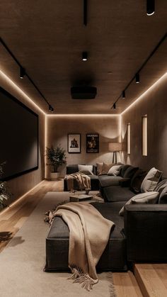 a living room filled with lots of furniture next to a wall mounted projector screen