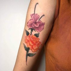 a woman with a flower tattoo on her arm