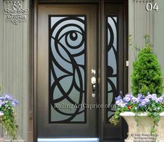 the front door is decorated with flowers and potted plants on either side, along with an ornamental glass panel