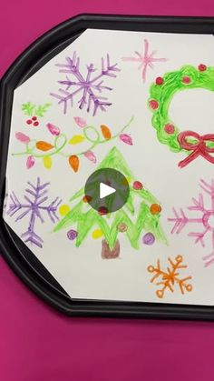 a child's drawing on a tray with snowflakes and christmas wreaths