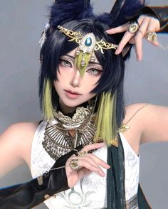 a woman with black hair and blue eyes wearing an elaborate headdress is posing for the camera