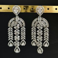 American Diamond earrings/Indian Jewelry/Pakistani Jewelry/Bollywood Jewelry/CZ earrings/AD earrings/Statement earrings/Gift for her Height = 70 mm || Width = 27 mm Bollywood Look American Diamond Earring Color, shades, and texture displayed may slightly vary from the actual product due to digital image limitations. We request you to consider these minor variations. Please expect the possibility of some slight imperfections when buying handmade jewelry. If you have any questions, please contact us. Please let me know if you have any questions. Thank you so much for visiting my shop. Hand Set Cubic Zirconia Dangle Danglers, Hand Set Cubic Zirconia Danglers, Silver Bollywood Chandelier Dangle Earrings, Bollywood Silver Dangle Chandelier Earrings, Heavy Bollywood Chandelier Earrings For Formal Occasions, Heavy Bollywood Chandelier Earrings For Formal Events, Bollywood Style Festive Cubic Zirconia Earrings, Bollywood Style Heavy Chandelier Earrings For Formal Occasions, Bollywood Style Dangle Earrings For Formal Occasions