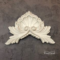 an ornate white wall decoration on a gray background