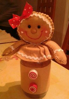 a gingerbread doll sitting in a jar on a table