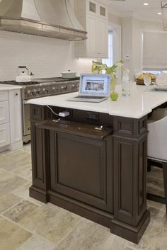 a kitchen island with a laptop on it