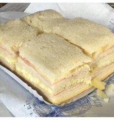 a sandwich cut in half sitting on top of a piece of paper