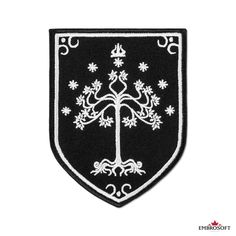 a black and white patch with a tree on it's side, in the shape of a shield