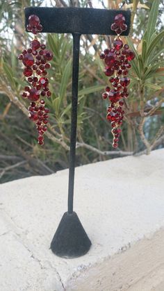 Deep red garnet earrings Length 3.5 inches long Red Ruby Dangle Chandelier Earrings, Burgundy Drop Earrings For Party, Burgundy Earrings For Party, Burgundy Gown, Red Garnet Earrings, Gold Rhinestone Earrings, Pageant Earrings, Heavy Earrings, Fun Ornaments