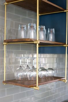 three shelves with glasses and bottles on them