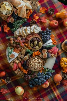 a table topped with lots of different types of fruits and veggies on top of a checkered cloth