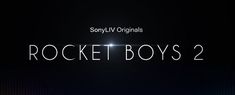 the title for rocket boys 2 is shown in white letters on a dark black background