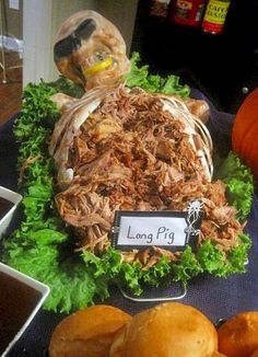 a table topped with lots of food and buns next to each other on top of a blue cloth