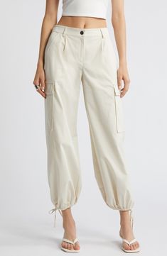 Drawstring ankle-length hems add versatility to these utilitarian cargo pants fashioned with recycled fibers. 28" inseam; 14" leg opening; 11 1/2" front rise; 13 1/2" back rise (size medium) Zip fly with button closure Front slant pockets; cargo flap-patch pockets Drawstring ankle hems 65% recycled polyester, 35% polyester Machine wash, tumble dry Imported Utility Cotton Cargo Pants With Cuffed Ankles, Cream Cargo Pants With Pockets For Workwear, Cream Cargo Pants For Workwear, Spring Pants With Side Pockets And Cuffed Ankles, Utility Cream Cargo Pants With Pockets, Spring Utility Parachute Pants With Tapered Leg, Beige Cargo Pocket Ankle-length Pants, Beige Cargo Jeans With Cargo Pockets For Spring, Beige Cargo Ankle-length Pants