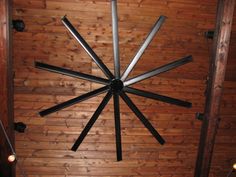 an overhead view of a wooden ceiling with metal rods in the shape of a star