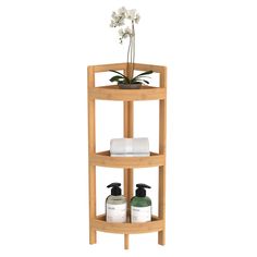 three tier bamboo shelf with soap and lotion bottles on the bottom, in front of a white background