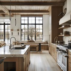 a large kitchen with wooden cabinets and white counter tops, along with an island in the middle