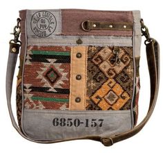 An amazingly delightful blend of tribal-inspired, vintage travel and Southwest themes combine all in one! The beautiful patterns and colors of the woven upcycled rug are the centerpiece. Patchwork canvas, leather, brad accents and fanciful overprinting complete the wonderfully unique look. Back is matching woven canvas with zippered pocket; adjustable, removable shoulder strap in aged leather. A beautiful bag! Materials Canvas , Rug & Leather Item Width 11.5 Item Depth 3 Item Height 13 Shoulder 22 Canvas Rug, Cotton Handbag, Leather Detailing, Bohemian Handmade, Boho Leather, Black Leather Purse, Fabric Craft, Western Boho, Pink Backpack