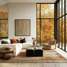 a living room filled with furniture and large windows