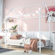 a white canopy bed in a pink bedroom with lights on the headboard and foot board