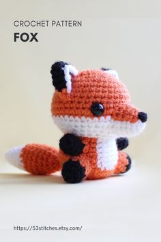 a small crocheted fox sitting on top of a table