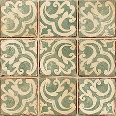 an old green and white tile pattern with swirls on the tiles in different colors