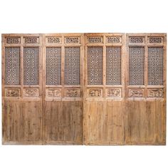 an old wooden screen with carved designs on the sides and bottom panel, set against a white background