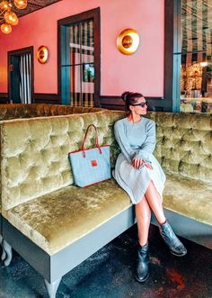 a woman sitting on a couch in a restaurant