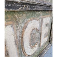 an old sign with the word ice painted on it's side and rusted paint