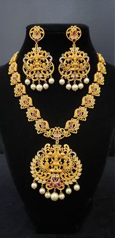 "Stunning Necklace with White, Ruby, Emerald, Pearls and Cubic Zircon. Handmade Indian Temple Jewelry, best to wear it for traditional ceremonies or Indian wedding. This bridal jewelry has ethnic finish. It has Cubic Zircon stones with ruby and emeralds. It is a Bollywood style one gram jewelry. There are long and short patterns of Indian jewelry in Kundan, Pearls, CZ, American Diamond , ruby, emerald, Polki, kemp to suit every occasion of South Indian and North Indian weddings. Handmade Indian Temple Jewelry Meenakari Necklaces For Marriage, Temple Jewelry Meenakari Necklace For Marriage, Intricate Design Necklace For Marriage And Diwali, Intricate Design Necklace For Marriage During Diwali, Intricate Diwali Necklace For Marriage, Temple Necklace With Intricate Design For Marriage And Festivals, Temple Jewelry Bridal Necklace For Diwali Wedding, Temple Jewelry Bridal Necklace For Marriage During Diwali, Intricate Temple Necklace For Marriage And Festivals