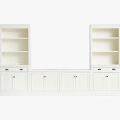 white bookcases with doors and drawers against a wall