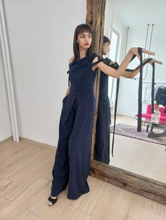 Our Dark Blue jumpsuit with Asymmetrical Neckline is made of: ℘ Carefully chosen fabrics, finest quality and perfect finishes  In the delicate but impressive details you can feel the love we have been working with! So when wearing this garment always have in mind how special and important person YOU are!   ℘ Sizes: From XS to XL - check out the size chart in the last picture   ℘ Custom fit: Your comfort in essential to us, so we can make the garment specially with your measurements. Please, make sure to write us    ℘ Care: * Hand Wash 30 ͦ degree * Machine Wash 30 ͦ degree    ℘ Delivery: The standard shipping takes: US & Canada: 10-15 biz days; Europe: 7-14 biz days; Everywhere Else: 10-15 biz days   ℘ Find more minimalist and authentic designs here: https://www.etsy.com/shop/LeBrandStudio Navy Sleeveless Fitted Jumpsuits And Rompers, Chic Navy Sleeveless Jumpsuits And Rompers, Elegant One-shoulder Blue Jumpsuits And Rompers, Elegant Blue One-shoulder Jumpsuit, Chic Blue One-shoulder Jumpsuit, Dark Blue Jumpsuit, Jumpsuit Formal, Navy Blue Jumpsuit, Jumpsuit Navy Blue