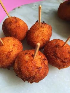 small appetizers with toothpicks in them on a plate