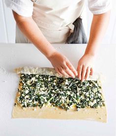 a person in an apron making food on a table