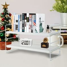 there is a clock on the shelf next to a christmas tree and bookshelf