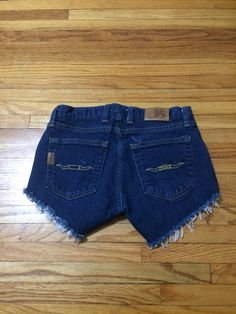 These jean shorts are perfect for anyone that loves Texas. If you want to look amazing all summer long, get these beauties today. They are in great condition and will make you look and feel great. They have no rips, holes, stains or smells. Measurements: laying flat and doubled Waist: 28 1/2 inches Hips: 33 inches Rise: 8 1/2 inches Inseam: 3 inches Length: 9 inches Size on tag: 2 Y2k Style Cutoff Medium Wash Shorts, Y2k Medium Wash Cutoff Shorts, Y2k Style Medium Wash Cutoff Shorts, Y2k Cutoff Jean Shorts With Pockets, Y2k Style Cutoff Jean Shorts With Pockets, Vintage Dark Wash Mid-rise Shorts, Y2k Medium Wash Jean Shorts, Vintage Style Mid-rise Dark Wash Shorts, 90s Style Dark Wash Short Length Bottoms