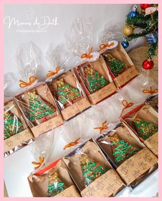 christmas cookies are wrapped in brown paper and tied with orange ribbon, sitting on a table