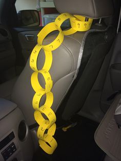 a car with some yellow tape on the back seat and two circles attached to it