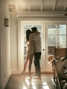 two people embracing in front of a door