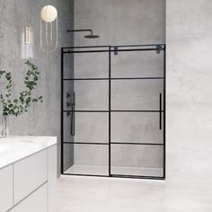 a white bathroom with a glass shower door