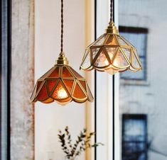 two lights hanging from a ceiling in a room