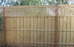 a wooden fence in the middle of a yard