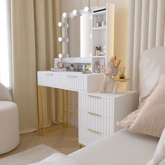 a bedroom with a white vanity and gold accents