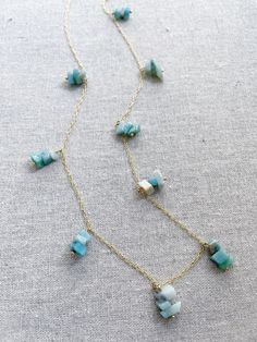 A gold necklace featuring groups of aquamarine stones. The aquamarine stone is used in holistic healing and crystal therapy. Spiritually, aquamarine is associated with trusting and letting go. In ancient times, aquamarine was believed to be the treasure of mermaids. Sailors used the stone as a talisman to bring good luck on the open waters. The gem was used as a symbol of protection and fearlessness too. Aquamarine 14k plated gold chain 30” long Shipping information Crystal Therapy, Chakra Necklace, Aquamarine Stone, Sterling Silver Hoop Earrings, Pink Quartz, Sterling Silver Hoops, Quartz Necklace, Love Yourself, Silver Hoops