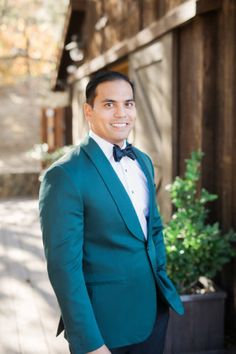 a man in a green suit and bow tie